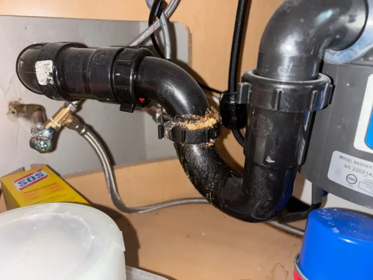 Kitchen sink drain trap with a cracked, leaking slip joint