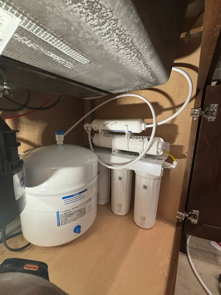 Under-sink reverse osmosis drinking water system installed in a kitchen cabinet
